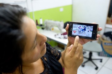 Nancy Salva, 41 Jahre, zeigt auf dem Smartphone ein Foto ihrer Neffen aus Bolivien - sie vermisst ihre Familie und Verwandten dort