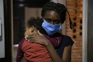 Eine Migrantin der Garifuna Ethnie aus Guatemala geht mit ihrem Sohn zur Krankenstation der Herberge  "Casa Mambré". Sie sind erst vor fünf Tagen angekommen und wegen der Corona-Pandemie müssen sie etwa zwei Wochen in Quarantäne bleiben.